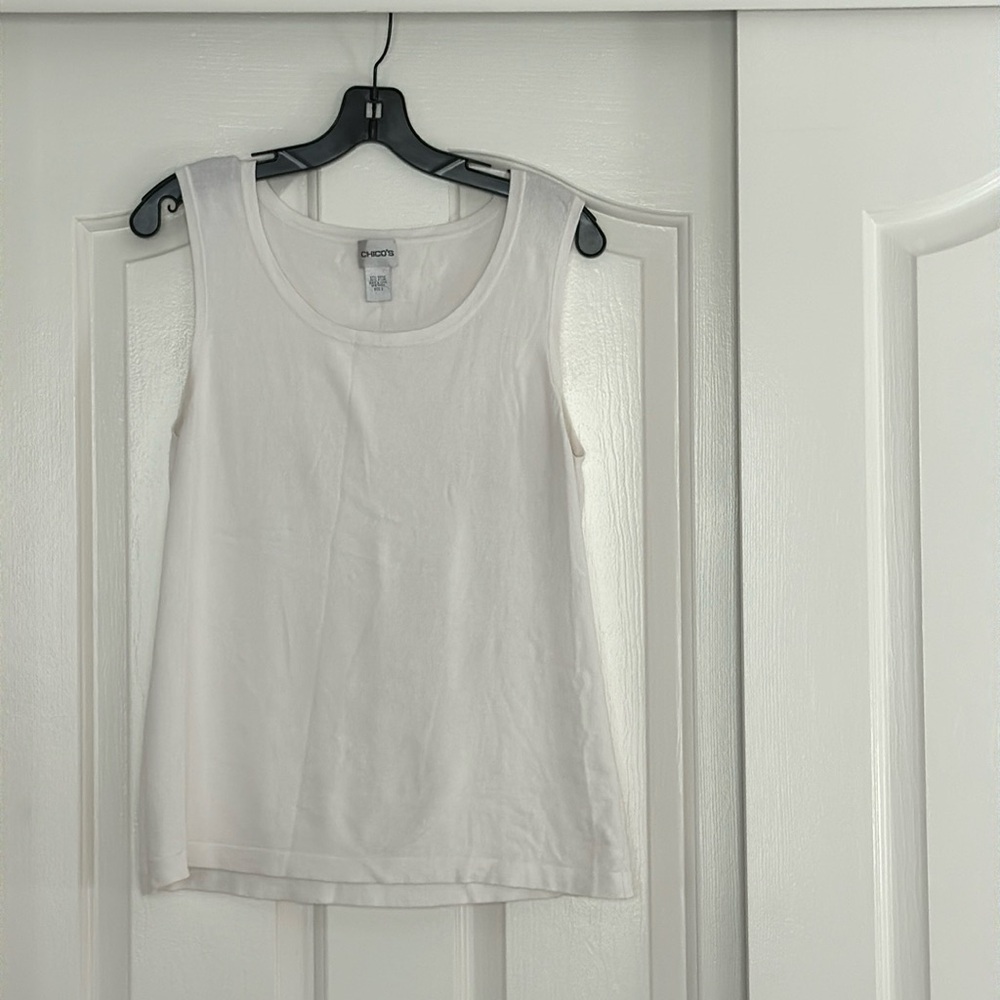 White Chico’s shell( tank). 57% Rayon, 43% Nylon. Sweater feel, scoop neck. SZ 2